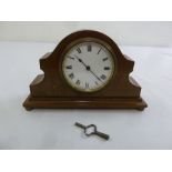 An Edwardian mantle clock of customary form, enamel dial with Roman numerals to include key