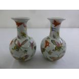 A pair of 19th century Chinese baluster vases, decorated with vari-coloured butterflies
