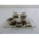 An Art Deco glass dressing table set to include tray, jars and covers and a ring stand
