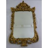 A gilded wooden shaped rectangular Baroque style wall mirror