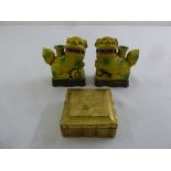 A pair of Oriental yellow glazed ceramic Dogs of Foe and a gold lacquered box