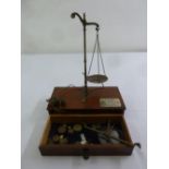 A cased set of mahogany and brass jewellery balance scales and weights