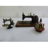Two vintage sewing machines and a cotton bobbin stand