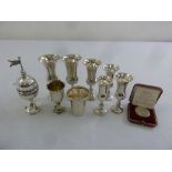 Eight silver Kiddush cups and a white metal spice box and cover