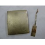 A silver engine turned cigarette case and a silver key ring