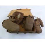 Two pairs of vintage leather boxing gloves and a leather bound suitcase
