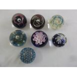 Seven paperweights of various design to include Caithness