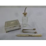 A quantity of silver to include a cigarette box, sugar tongs, a butter knife and a cut glass