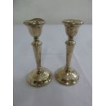 A pair of filled silver table candlesticks, London 1920, A/F