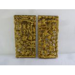 A pair of Chinese carved and pierced gilded wooden wall decals depicting family scenes, 53.5 x 25cm