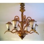 A Murano glass six branch chandelier, the scrolling arms supporting brown glass lantern shades, A/F