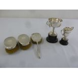 Two silver mounted hair brushes, a dressing table mirror and two silver trophy cups