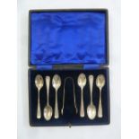 A cased set of six silver coffee spoons and matching pair of tongs