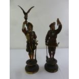 A pair of late 19th century continental cold painted figurines on raised circular plinths A/F