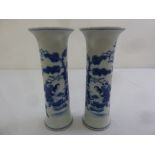 A pair of Chinese Kangxi blue and white cylindrical vases decorated with courtiers in stylised