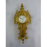 A late 19th century French ormolu wall clock with white enamel dial and Roman numerals in the