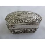 An Indian white metal hexagonal box with hinged cover, the side decorated with stylised animals