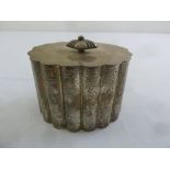 A Continental white metal tea caddy of fluted oval form with flat hinged cover