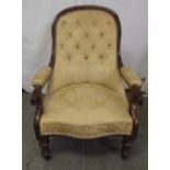 A Victorian mahogany upholstered armchair on turned legs with original castors