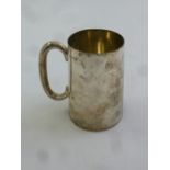 A silver mug tapering cylindrical with scroll handle, Sheffield 1903