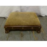 An Arts and Crafts style rectangular foot stool with brass button decoration
