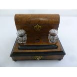 A Victorian walnut Standish of rectangular form with glass inkwells and domed hinged cover to