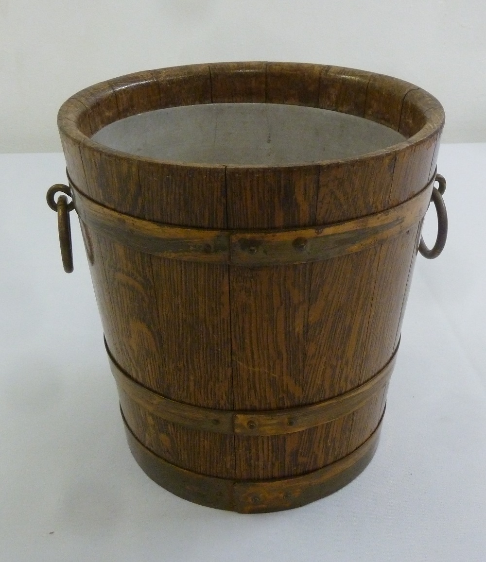 An Edwardian oak planter with brass mounts and side handles