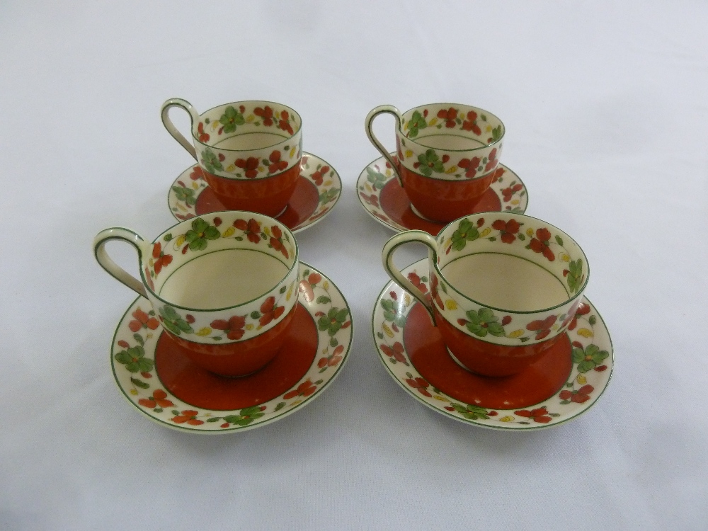 A set of four Porsgrund Norge terracotta coffee cups and saucers