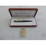 Cartier ballpoint pen in original packaging and a Colibri gilded metal money with 14ct gold inset