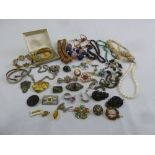 A quantity of costume jewellery to include brooches, necklaces and bracelets