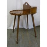 An Edwardian mahogany shaped oval sewing table on four tapering rectangular legs