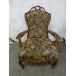 A Victorian upholstered mahogany armchair on cabriole legs