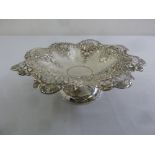 A silver fruit stand, lobed circular, pierced and embossed with flowers on raised circular base,