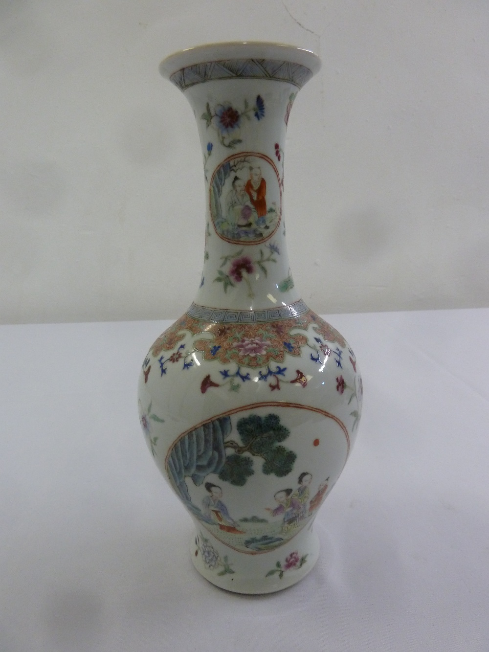 A Chinese 18th century baluster form vase decorated with figures and vegetation