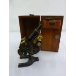 A brass microscope by Watson & Glover in fitted mahogany case