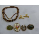 A quantity of costume jewellery to include brooches and cufflinks