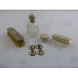 A quantity of silver to include two dressing table jars, a silver clothes brush and four buttons