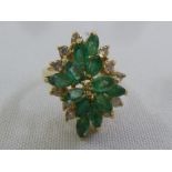 A yellow gold diamond and emerald dress ring tested 9ct