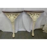 A pair of cast iron consol tables with mahogany D shaped tops