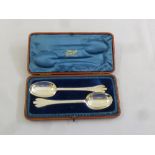 A pair of Britannia standard rattail pattern serving spoons in fitted case, London 1905