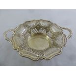 A shaped circular silver sweetmeat basket, latticed pierced sides and two scroll side handles,