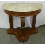 A mahogany marble top hall table on three scrolling supports and triform base