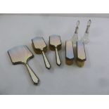 A five piece silver and enamel dressing table set and two dressing table bottles with silver