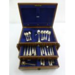 A quantity of Kings pattern silver flatware to include spoons, forks and ladles in a table top