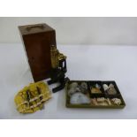 A 20th century brass microscope in fitted mahogany case and a quantity of rocks and fossils