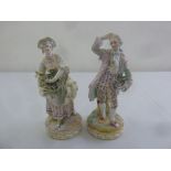 A pair of 19th century porcelain figures in 18th century style costume on raised circular bases,
