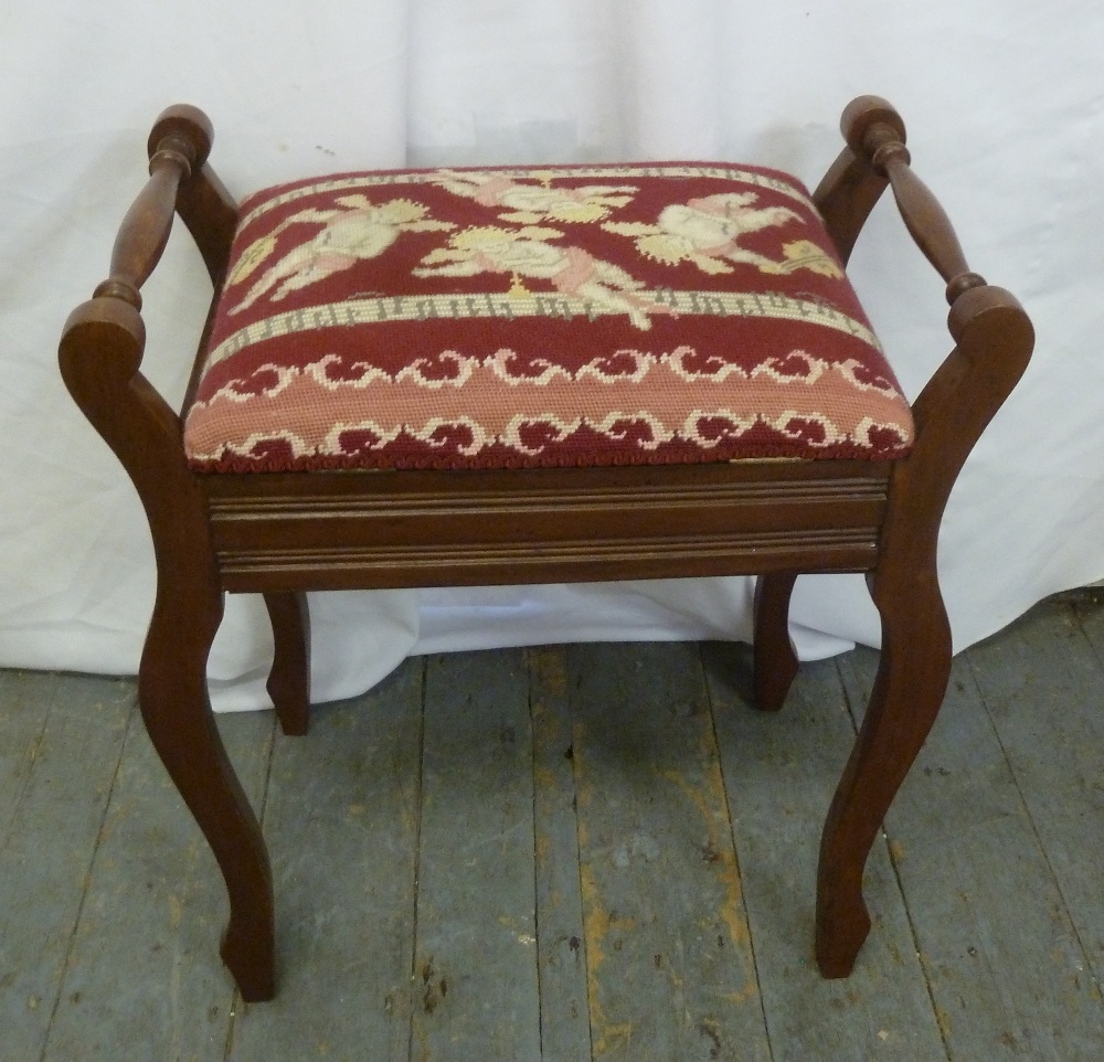 A mahogany rectangular piano stool with hinged upholstered seat