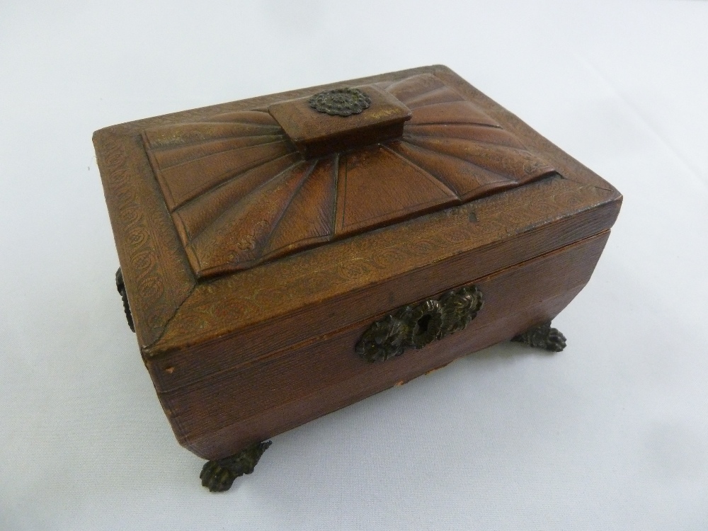 A Regency leather sarcophagus shaped work box with brass mounts on four paw feet