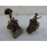 A pair of amethyst sculptures with applied metal work enamel and porcelain of figures in a fairytale