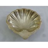 A silver shell shaped nut dish